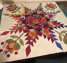 a quilted table top with flowers on it