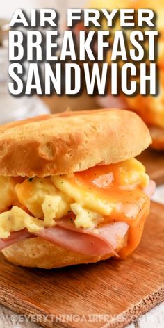 an air fryer breakfast sandwich on a cutting board with the words, air fryer breakfast sandwich