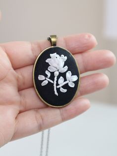 "Black and white Rose pendant necklace. Boho flower necklace.  Embroidery jewelry. Mother's day jewelry gift. Shape: Oval Size: 3 x 4 centimeters ( about 1.2 x 1.6 inches) - You will get 1 pendant with 1 chain necklace with the length of your choice. Each set comes with crafted gift box with carefully hand-tied ribbons. - Chain length options: Short (18\"), Medium (24\"), and Long (30\"). Customized sizes are also welcome. Just convo me:). - Materials: silk ribbons, natural silk fabric (made in White Rose Design Necklace As Gift, White Rose Design Necklace For Gift, White Jewelry With Rose Design As Gift, White Jewelry With Rose Design For Gift, White Rose Design Necklace For Wedding, Handmade White Flower Pendant Necklace, White Pendant Flower Necklace For Mother's Day, Necklace Embroidery, Rose Pendant Necklace