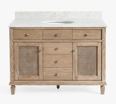 a bathroom vanity with white marble top and wooden cabinetry, sideboard or sink