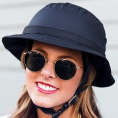 a woman wearing a black hat and sunglasses