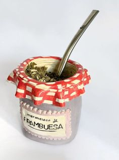 a jar filled with food and a spoon sticking out of it's top lid