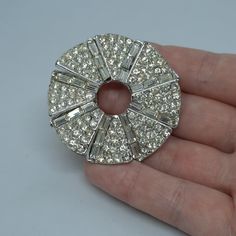 Vintage rhinestone brooch. Gloss silver tone flower brooch with a clear rhinestone pin. Brooch size: 4.5 cm/1.8 inches. Mark- unsigned. Condition- good vintage. Maybe you want to see other brooches too: https://www.etsy.com/shop/VintageVoyageLT?ref=seller-platform-mcnav&section_id=32157229 You can write me a message if you have any questions. Glad you visited my store! Have a great time! Glamorous Silver Bling Brooch, Sparkling Silver Brooches For Evening, Silver Sparkling Brooches For Evening, Silver Crystal Round Brooches, Silver Crystal Brooch With Sparkling Stones, Silver Rhinestone Round Brooches, Silver Crystal Brooches With Sparkling Stones, Silver Round Brooches With Rhinestones, Sparkling Silver Brooch For Anniversary