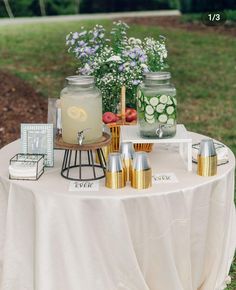 a table topped with jars filled with drinks