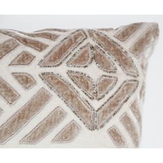 a brown and white pillow on a white background