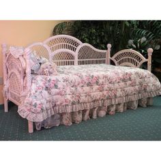 a white daybed with pink flowers on it