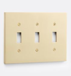 three light switch plates on a white wall