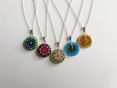 "This is a small (2cm) circular glass millefiore pendant available in different colour options (select from the drop down menu). I described the colours with main centre colour first then main edge colour second. The thickness of the disk is about 3mm. \"Millefiori\" is a Murano glass technique. It means \"thousand flowers\" in Italian. The pendants are great at catching the light and each one has a unique millefiore glass pattern. The charm is suspended with a small bail on a silver plated generous 20 inch 2mm cable chain. If you prefer it on a black cord (17\") please add a note at checkout. Supplied in an organza bag. I also have some lampwork evil eye disc pendants you may like here https://www.etsy.com/uk/listing/1596479817/lampwork-evil-eye-pendant-blue-black?click_key=2651fc83150c22 Green Necklace With Flower Charm And Round Pendant, Nickel-free Round Glass Jewelry, Nickel-free Multicolor Round Pendant Jewelry, Multicolor Nickel-free Round Pendant Jewelry, Multicolor Murano Glass Round Necklace, Multicolor Round Pendant Jewelry With Adjustable Chain, Multicolor Round Pendant With Adjustable Chain, Multicolor Adjustable Chain Round Pendant Jewelry, Multicolor Jewelry With Adjustable Chain And Round Pendant