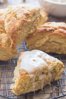 biscuits with icing sitting on a cooling rack