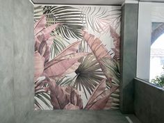 a bathroom with a large wall mural in the corner