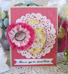 a close up of a greeting card on a table with flowers and eggs in the background