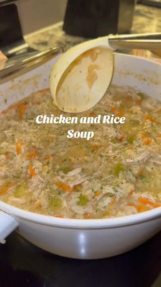 chicken and rice soup in a white bowl with a ladle scooping it out