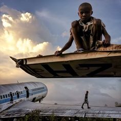 a man standing on top of an airplane