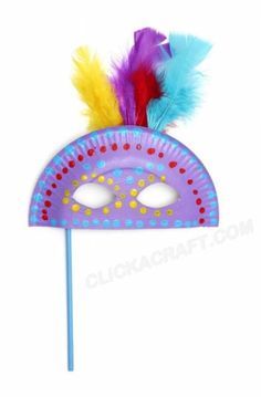 a purple mask with colorful feathers on it's side and a blue stick sticking out of