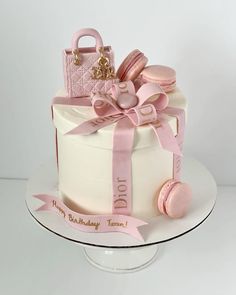 a birthday cake decorated with pink and gold decorations