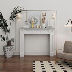 a living room with a couch, table and potted plants on the floor in front of it