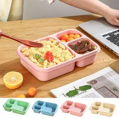 the lunch box is filled with noodles, meat and vegetables as someone uses a laptop