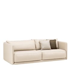 a white couch with two pillows on it's back and the seat upholstered