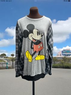 a mickey mouse t - shirt is on display outside