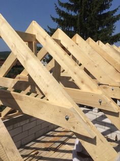 the roof trusses are being installed on top of the house's roofing