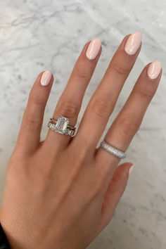 a woman's hand with two rings on it and one ring in the middle