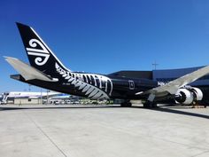 an air new zealand plane parked at the airport