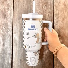 someone is holding onto the handle of a travel mug