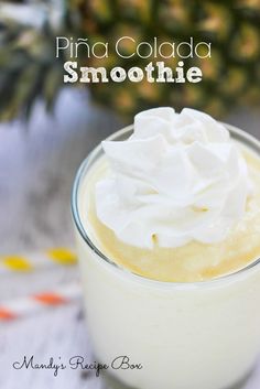 pine cola smoothie with whipped cream in a small glass on a white tablecloth