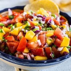 a blue bowl filled with fresh fruit and salsa