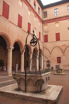 an old fountain in the middle of a courtyard