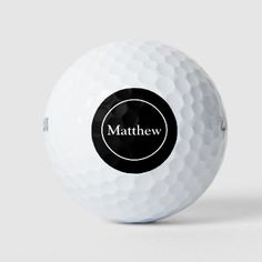 a white golf ball with the word mathew on it's front and side