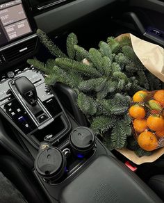 the interior of a car is decorated with oranges and pine cones, along with other decorations