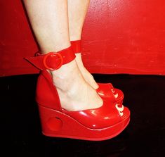 "PEEPHOLE Platform Sandals in Red Patent Handcrafted to order in London Red Sandals with removable wide ankle strap and hole going through Platform at back.  Platform made of wood and covered in red patent leather Genuine leather : upper and platform cover is made of Red patent leather. Wedge height: 1.1\"inches (3cm) at front and 3.1\"inches (8cm) at back Ankle strap is 1.3\"inches (3.3cm) wide and fastens with large red buckle With an arch height of 2\"inches (5cm) these shoes are fitted with Donut Shoes, 1970s Shoes, Pottery Owl, 70s Mode, Red Wedges, London Red, Red Sandals, Shoe Company, Shoes Summer