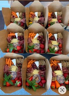 six boxes filled with assorted fruits and veggies on top of a table