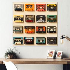 there is a wall mounted with cassettes on the wall and a table next to it