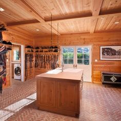 a large kitchen with wooden walls and flooring