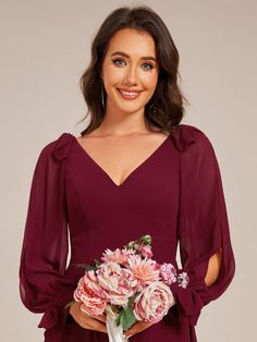 a woman in a red dress holding a bouquet of flowers