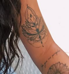 a woman with a flower tattoo on her arm