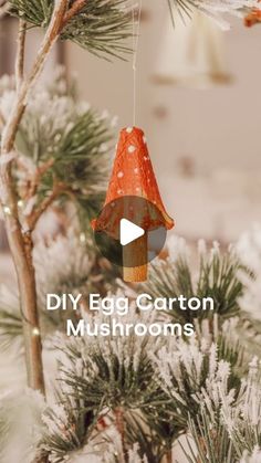 an ornament hanging from a pine tree with the words diy egg carton mushrooms