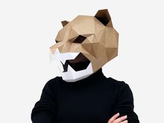 a person wearing a paper mask with a bear's head on top of it