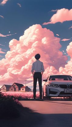 a man standing in front of a car looking at the clouds