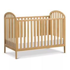 a small wooden crib with white sheets on the bottom and side rails, in front of a white background