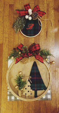 two christmas decorations on top of a wooden floor next to each other, one with a monogrammed tree