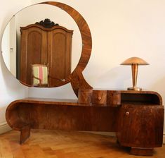 an antique wooden dressing table with mirror and lamp