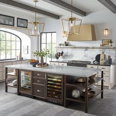 a kitchen with marble counter tops and an island in front of the stove top oven