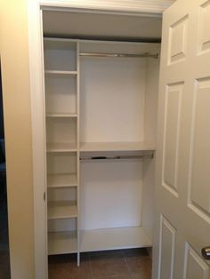 an empty walk in closet next to a door