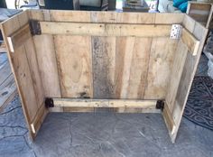 a large wooden box sitting on top of a cement floor