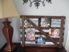 an old wooden pallet with pictures on it and a lamp next to the wall