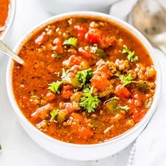 two bowls filled with soup and garnished with cilantro