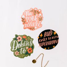 three stickers with words and flowers on them